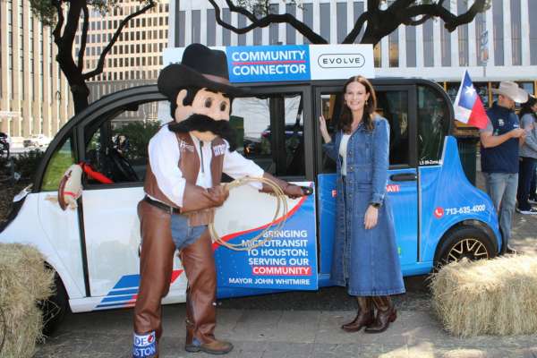 Meredith Johnson stands in front of a Community Connector vehicle.